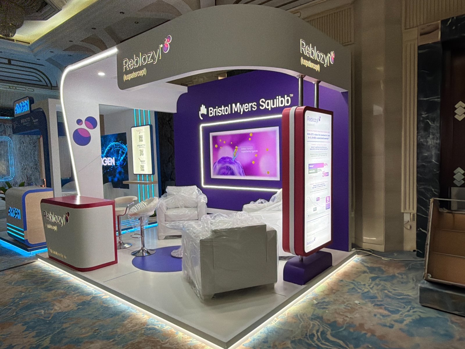 Reema team installing graphics and screens on an exhibition booth